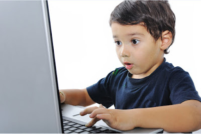 Young boy using a laptop Young boy using a laptop