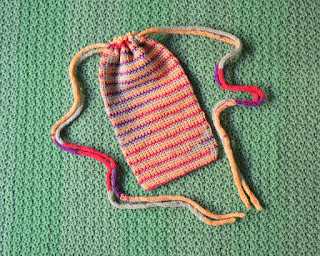 Crocheted drawstring bag laid flat.
