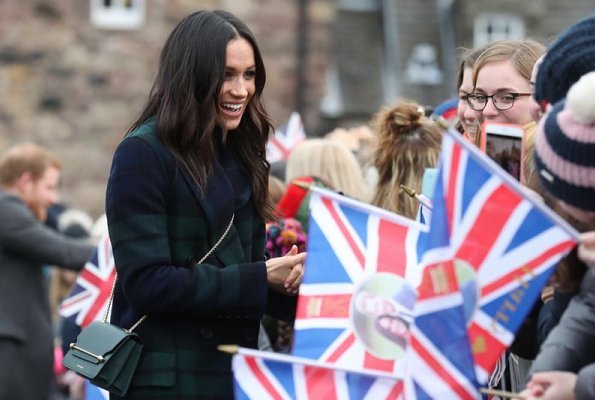 Meghan Markle wore a double-breasted tartan wool-blend coat by Burberry during Edinburgh visit. Meghan carried Strathberry Mini crossbody bag