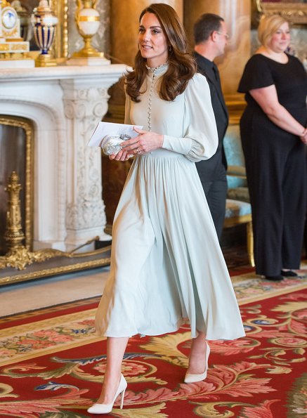 Meghan Markle wore  Amanda Wakeley coat, Kate Middleton is wearing a midi dress with ruffle detail