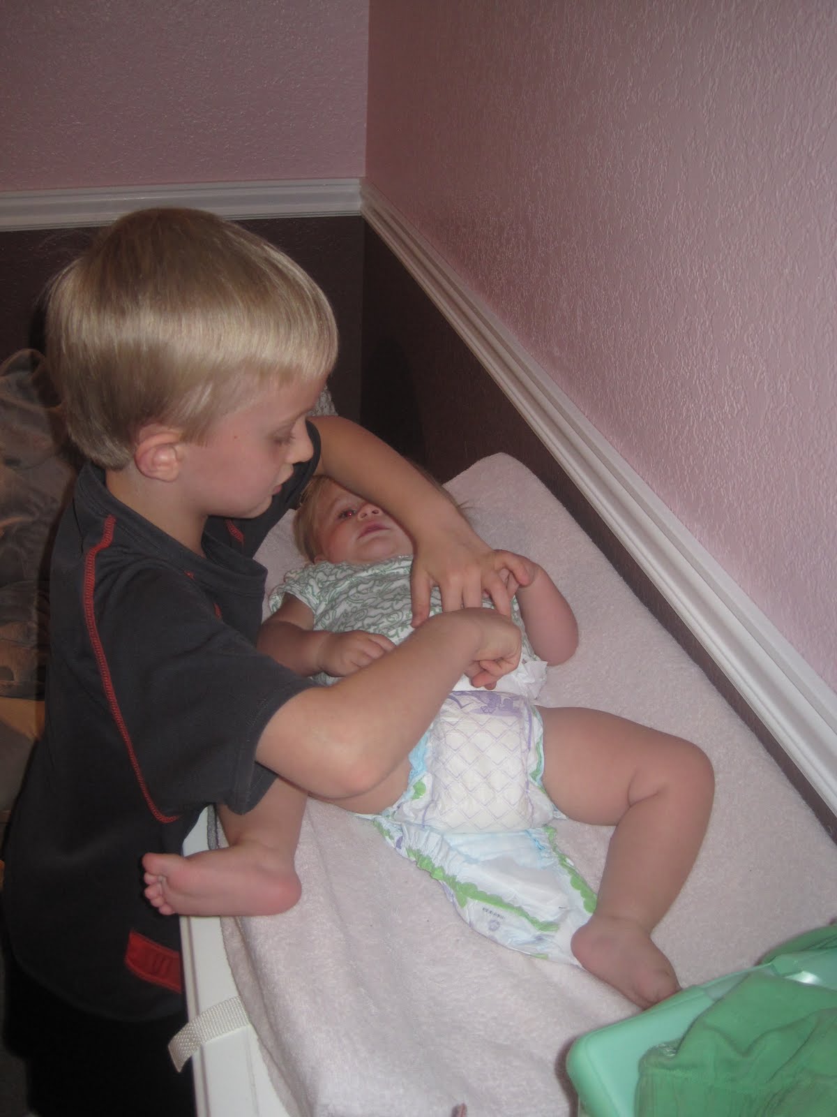 THE ROTHHURST FAMILY Jaycoby changed Ella's diaper