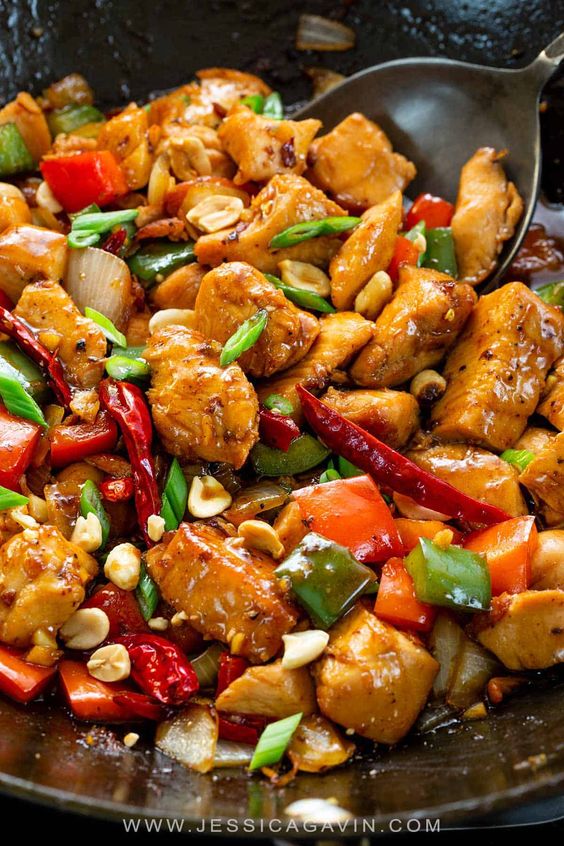 Kung pao chicken recipe with bell peppers, onions, lean white meat, and a spicy sauce that rivals authentic Chinese takeout! #kungpaochicken #chinesefood #asiancuisine #stirfry