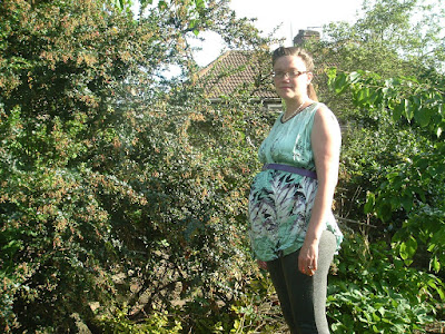Pregnant woman standing in a garden