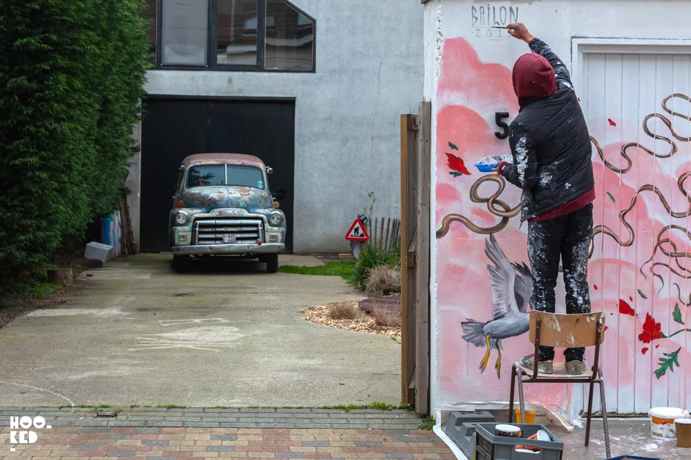 Brazilian street artist Mateus Bailon pictured at work on a mural in Ostend, Belgium