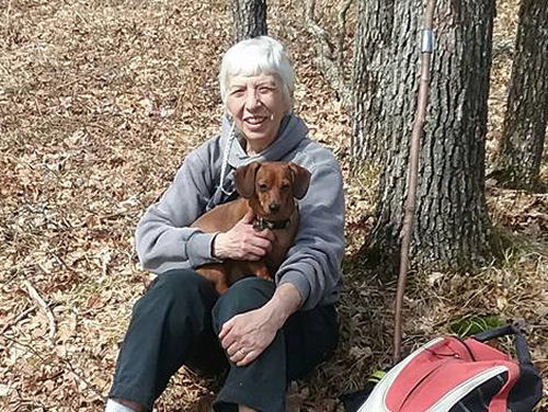 hiker holding a dog