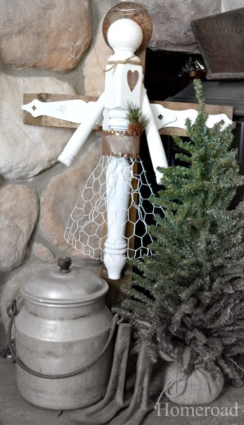 Junky angel on mantel with tree