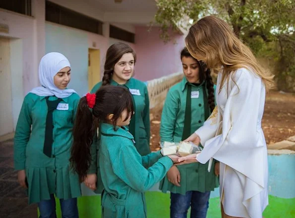 Queen Rania of Jordan wears Valentino coat and trousers, Valentino Rock Pumps and Valentino rock handbags