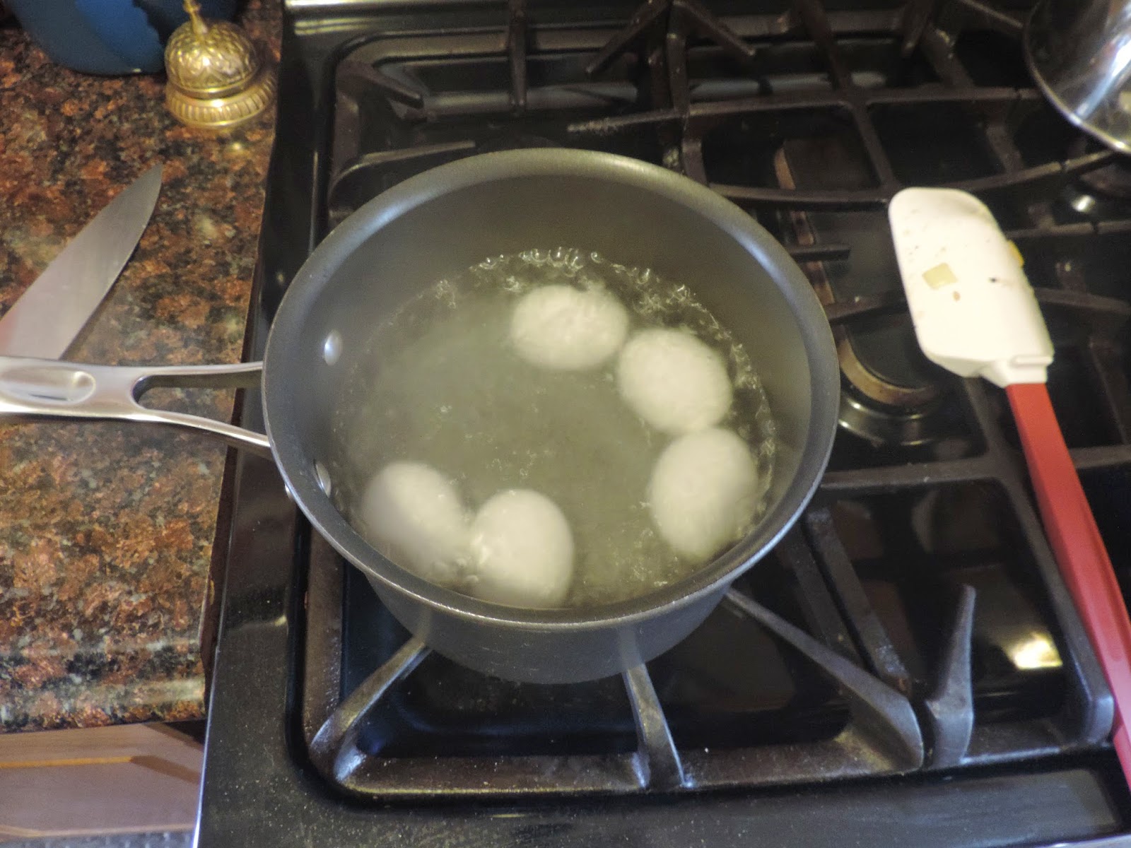 The water with the eggs in it being brought to a boil. 