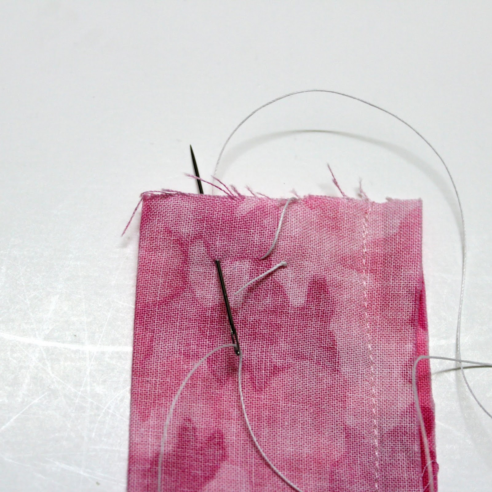 Now sew two stitches at one end of the tube, take care of sewing