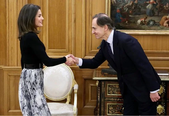 Queen Letizia wore Zara snakeskin print belted skirt, and Hugo Boss top, and Magrit suede boots at Vogue Spain