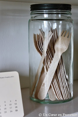 Wooden kitchen utensils 'Milk and Paper' in an old glass jar