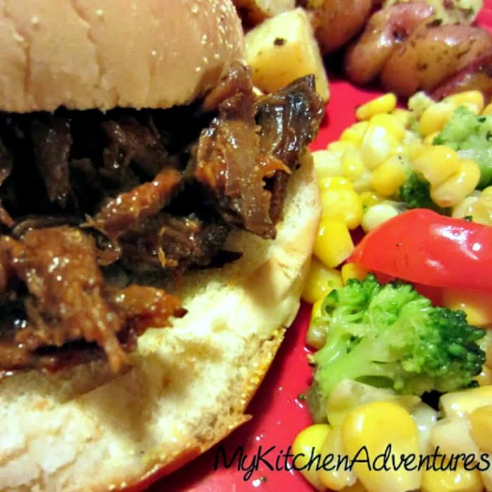 Slow Cooker BBQ Beef on bun with veggies on the side