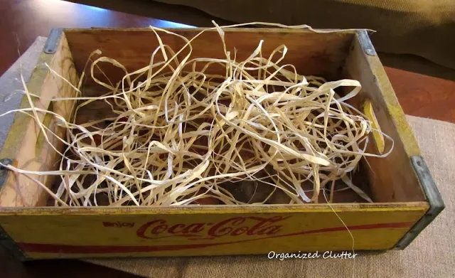 Filling a fall crate with raffia
