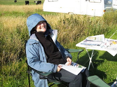 Lola II in field with newspapers