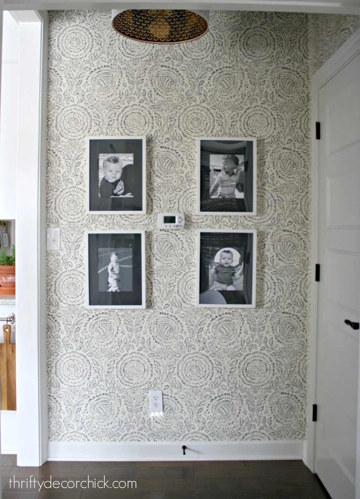 Gallery wall with wallpaper in hallway 