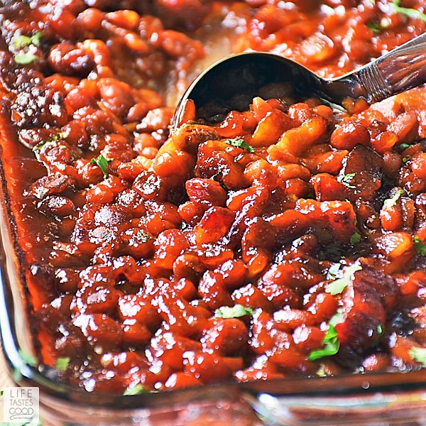 Cowboy Baked Beans in baking dish with a ladle for serving