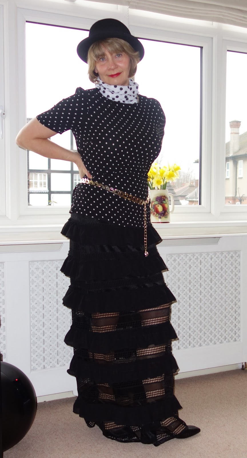 Gail Hanlon in black flouncy maxi skirt, hat and polka dot top