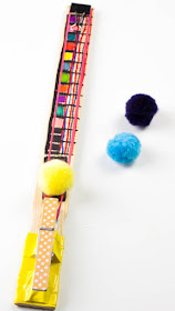 Easy Rubber Band Pom Pom Shooter Toy - Super Fun STEAM project to craft with kids.  You probably already own all the materials!
