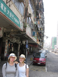 Girls in front of low level building.