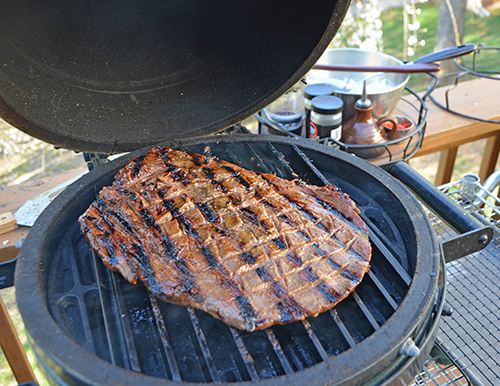 Flank steak grilling on a Big Green Egg mini-max with #GrillGrates