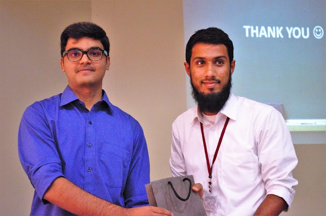 Syed Faizan Ali giving gifts to the winner of the Q/A Session