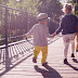 Baby Boy and Girl Walking on Bridge