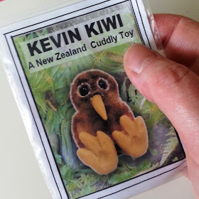 Hand holding a kit packet for Kevin Kiwi 'A New Zealand cuddly toy'