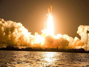 SPACE SHUTTLE DISCOVERY LIFTS OFF INTO A DARK SKY