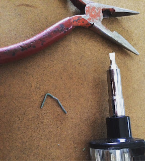 Taking staples out of the back panels one by one