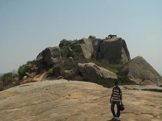 Hiker stands in front of the summit at Devarayanadurga trek
