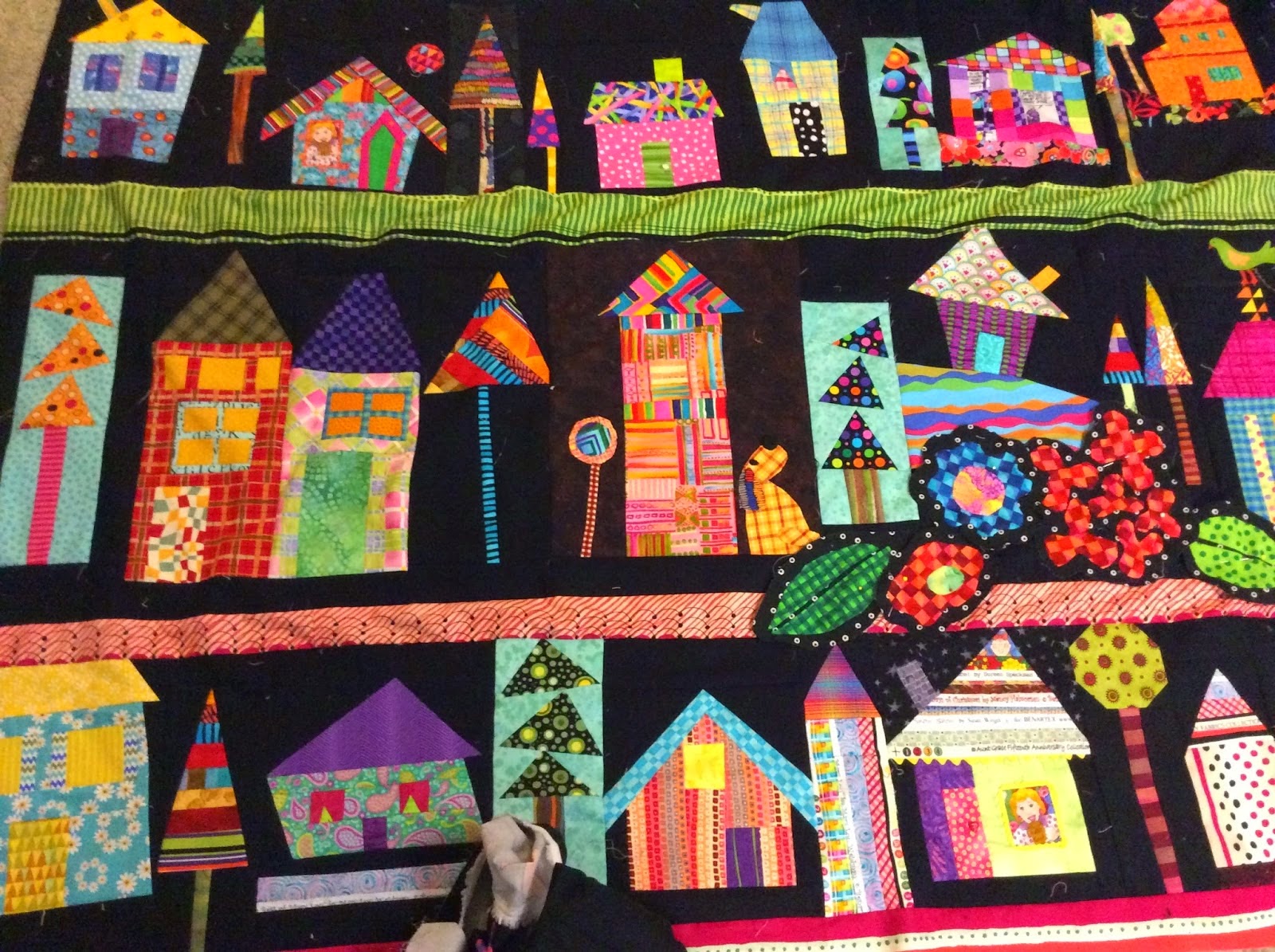 House quilt is done and quilted with fun details and whimsical things to smile at