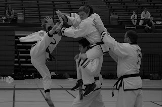 Black belt breaking a board in taekwondo and karate lessons