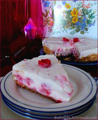 White Chocolate Raspberry Refrigerator Cheesecake, melted white chocolate and fresh raspberries flavor this no-bake cheesecake in a vanilla cookie crust | Recipe developed by www.BakingInATornado.com | #recipe #dessert