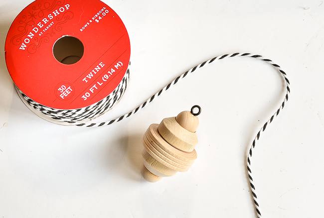 Adding bakers twine to ornaments for hanging
