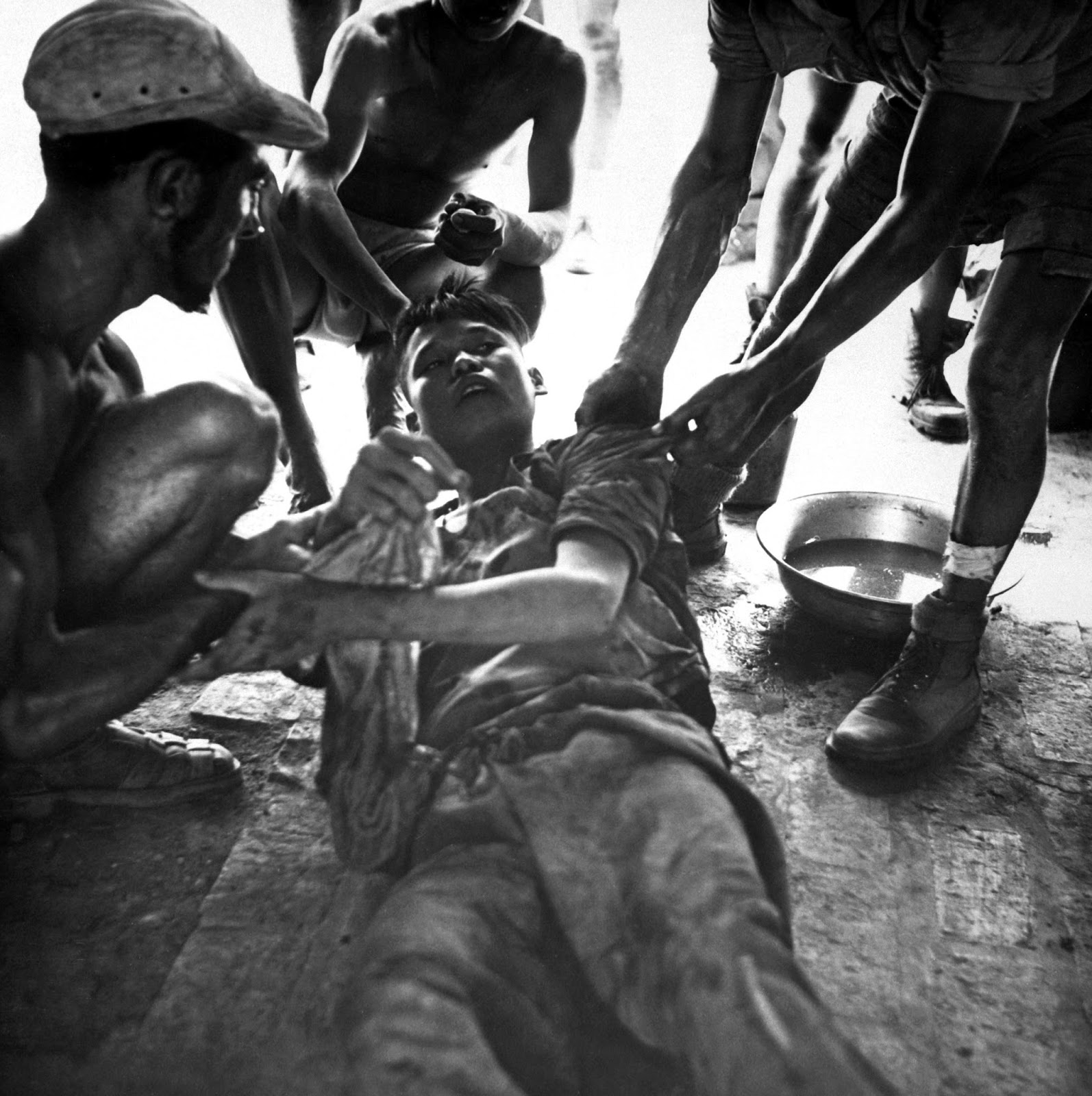 36 Amazing Historical Pictures. #9 Is Unbelievable - A wounded Vietminh prisoner is given first aid by Franco Vietnamese medics after firefight near Hung Yen, south of Hanoi, Vietnam (1954)