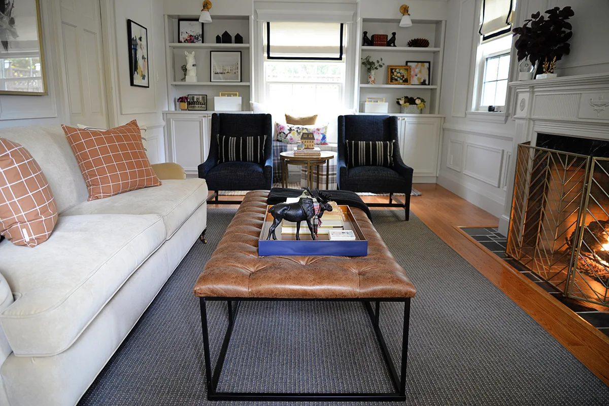 A HomePop brown tufted ottoman brings masculine cozy style to a traditional living room