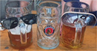 beer glasses dressed with sunglasses using handle as nose