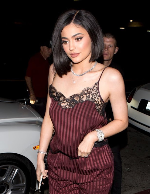 Kylie Jenner continues to show off her HUGE diamond 'engagement ring' as she steps out in a jumpsuit