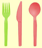 Green fork next to red spoon and knife