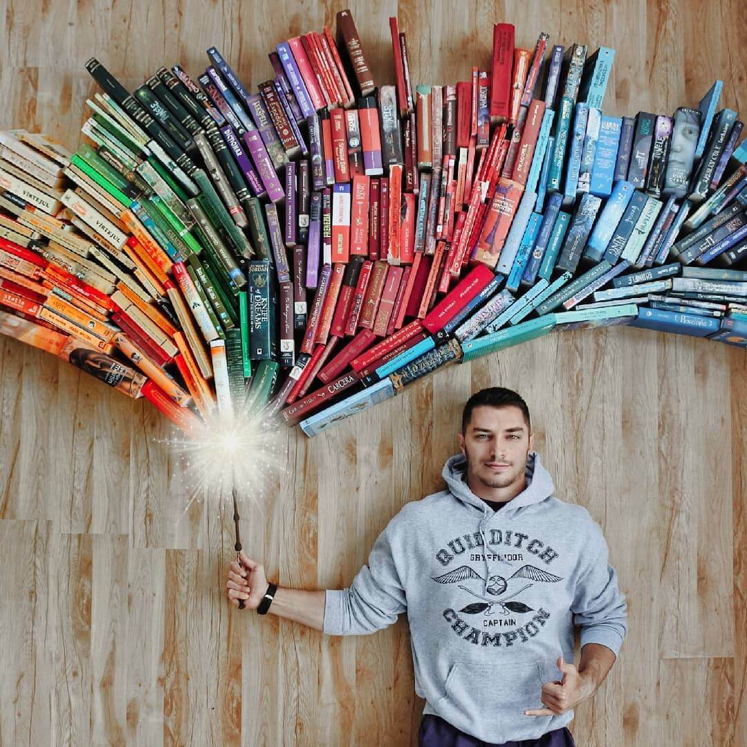 Guy Creatively Arranges His Huge Library of Books Into Artistic Scenes