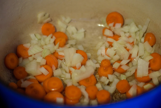 Carrots and onion sautéing in the pot. 