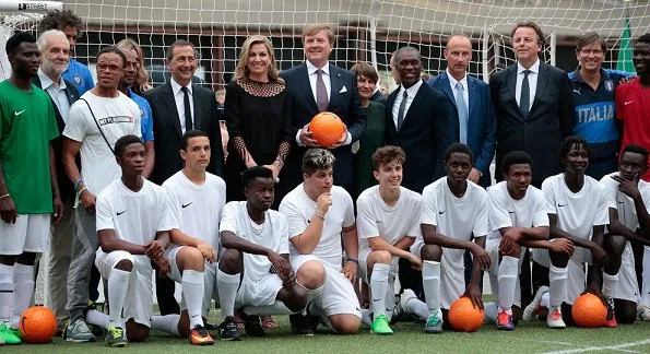 Queen Maxima and King Willem-Alexander attended a Football Clinic. Queen Maxima wore black long dress in Milan