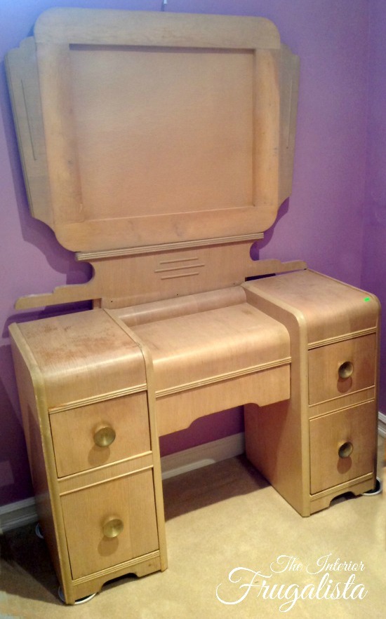 How to give a vintage waterfall vanity a drab to fab hollywood glam makeover with metallic paint, wrapping paper, and pearl embellished knobs.