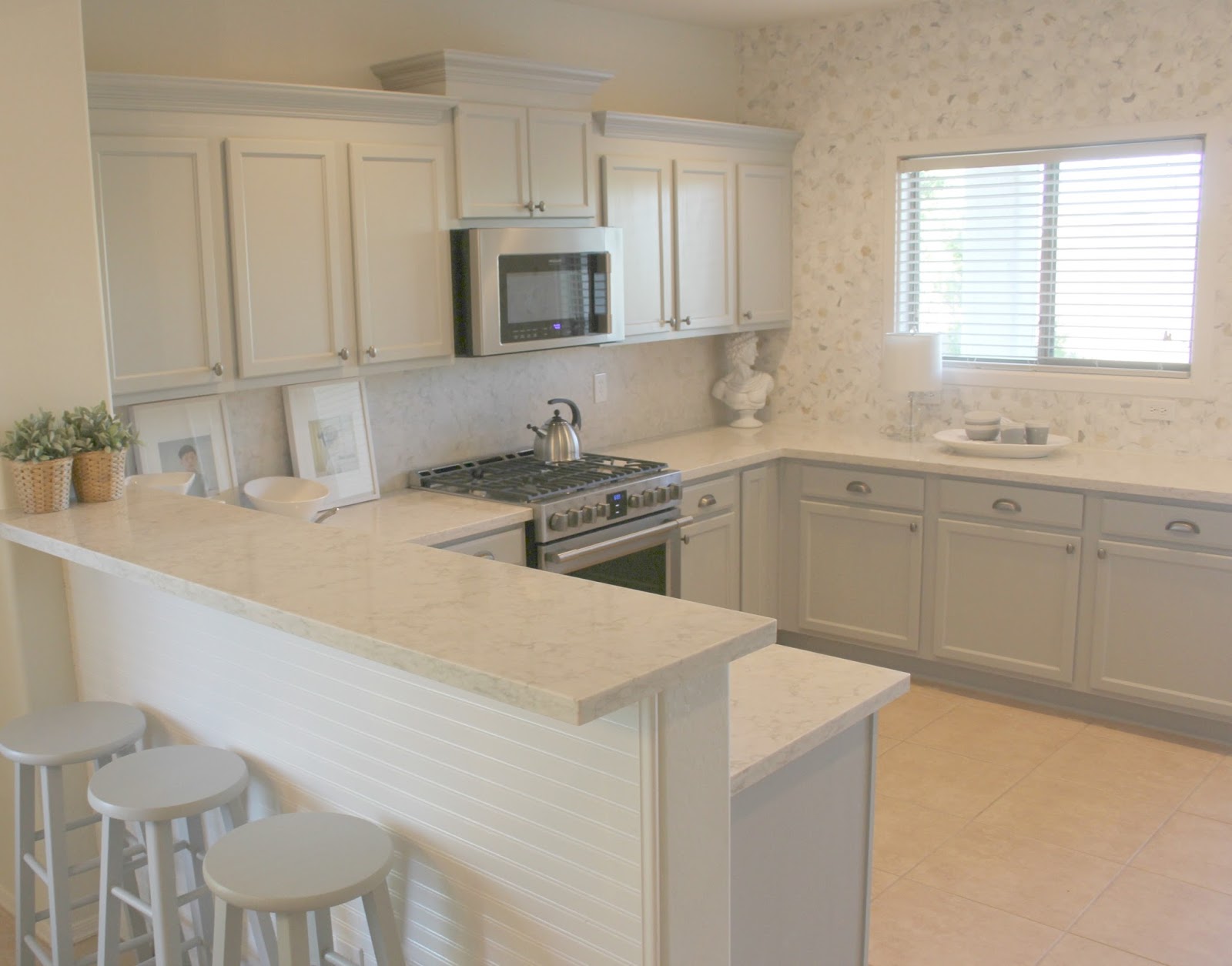 Serene Nordic French style kitchen renovation with pastels and grey cabinets by Hello Lovely studio