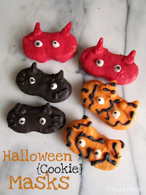 nutter butter cookies decorated to look like halloween masks: devils, cats, tigers
