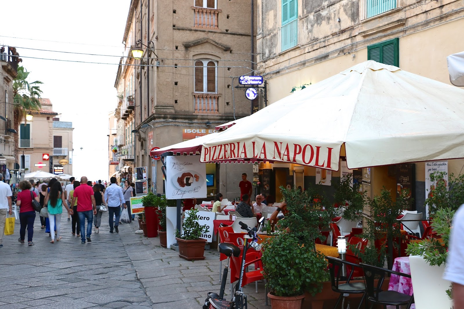 a girl wanders through italy in a red dress
