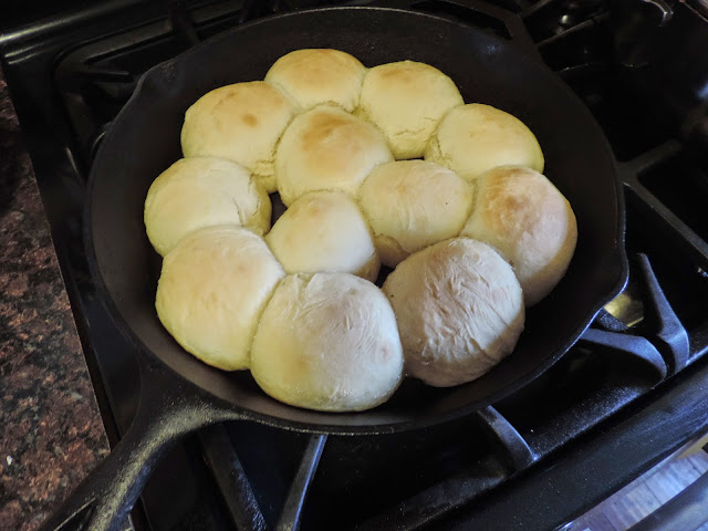 The homemade dinner rolls fresh out of the oven in the cast iron skillet. 