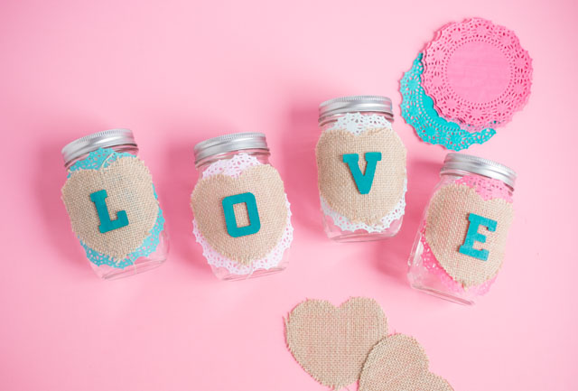 These mason jars filled with doily flowers are a pretty DIY Valentine's Day decoration or centerpiece! #valentinecrafts #valentinescrafts #masonjarcrafts #doilycrafts #doilyflowers #paperflowers #valentinesdaycrafts These mason jars filled with doily flowers are a pretty DIY Valentine's Day decoration or centerpiece! #valentinecrafts #valentinescrafts #masonjarcrafts #doilycrafts #doilyflowers #paperflowers #valentinesdaycrafts