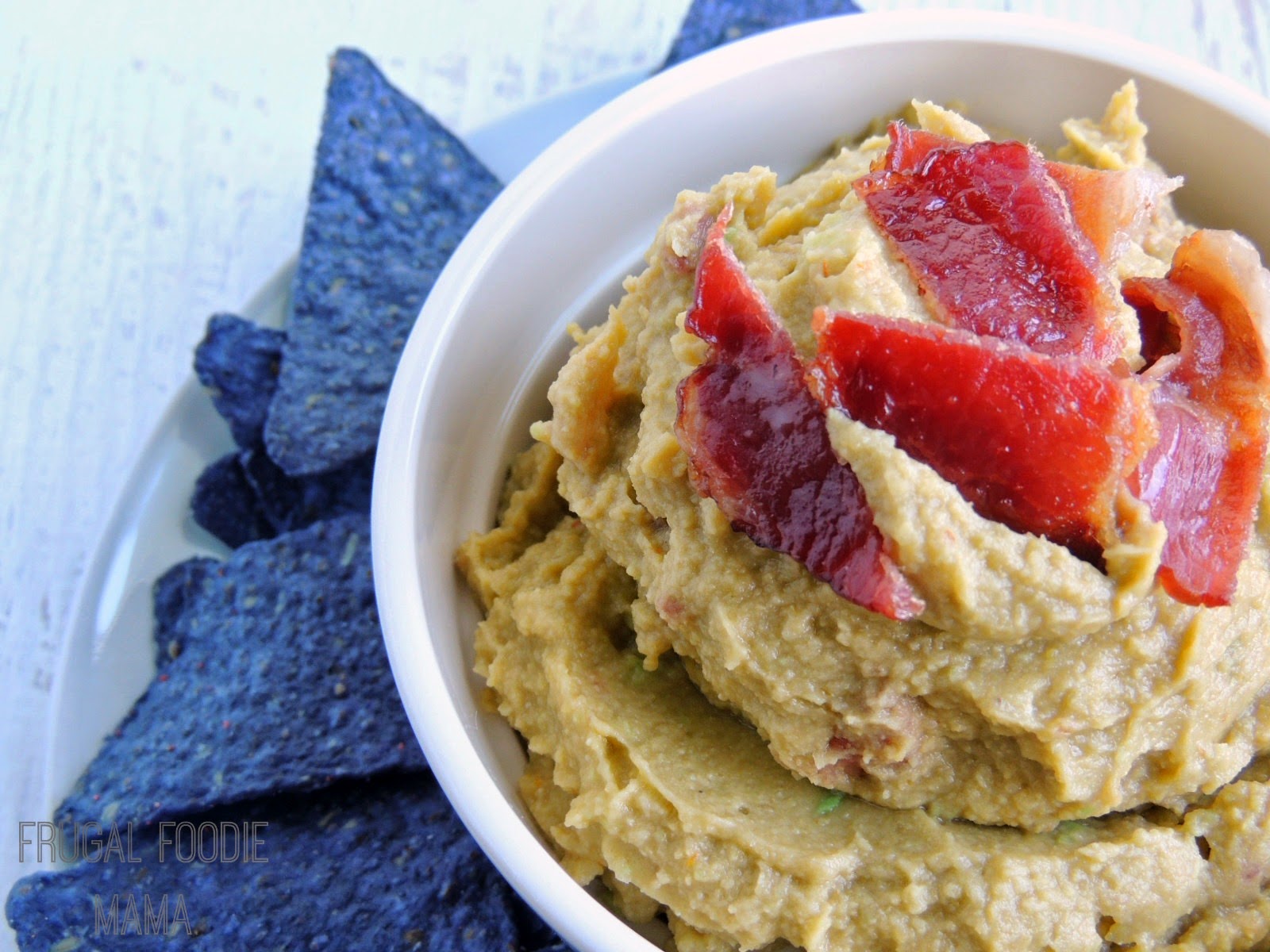How can you make your three favorite chip dips even better? Combine them together and then throw some bacon in there, like in this Bacon Guaca-Hummus.