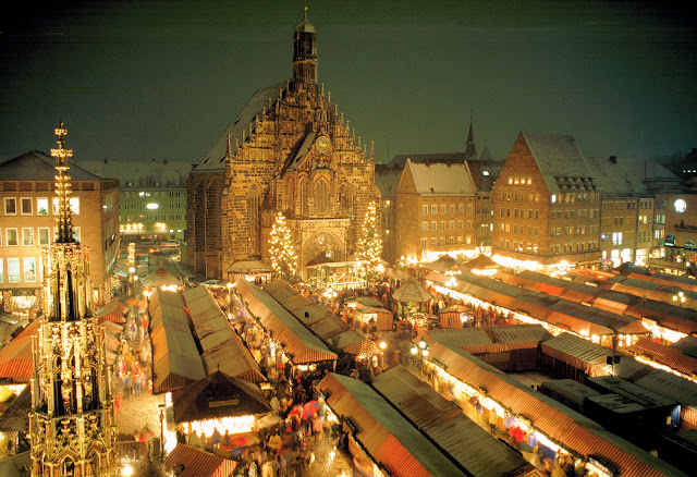 The Nürnberg Christkindlmarkt lining Hauptmarkt Square is also known as the 'Little Town of Wood and Cloth' due to its vibrant red and white ribbons decorating more than 200 Alpine chalets. Photo: WikiMedia.org.